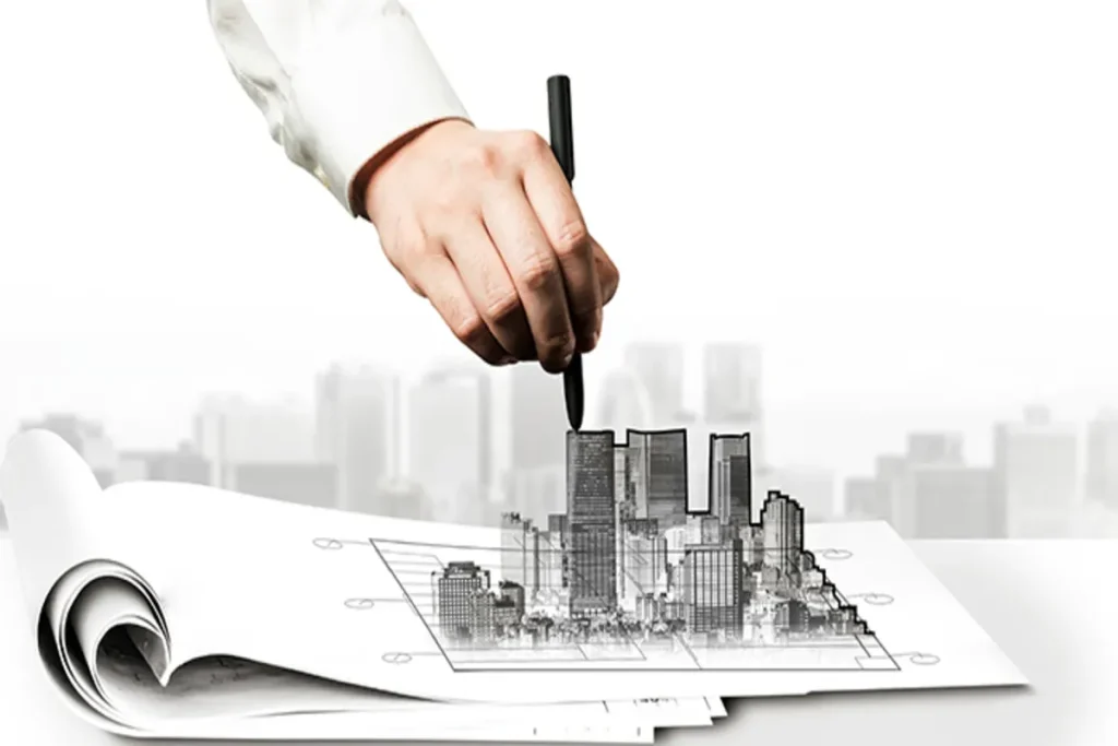 Mão de um profissional desenhando a silhueta 3D de edifícios sobre uma planta arquitetônica, simbolizando o planejamento de incorporação imobiliária.